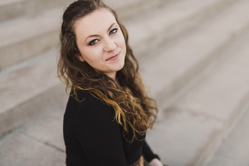 simple minimal portrait of woman sitting on museum steps