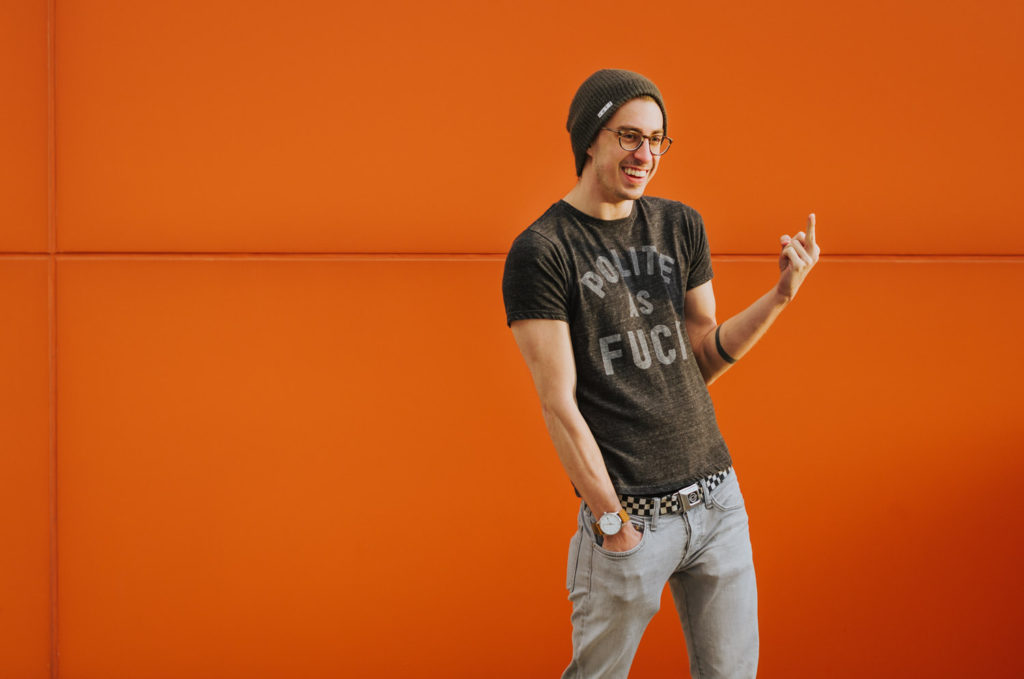 orange wall male fashion model polite as fuck tshirt middle finger