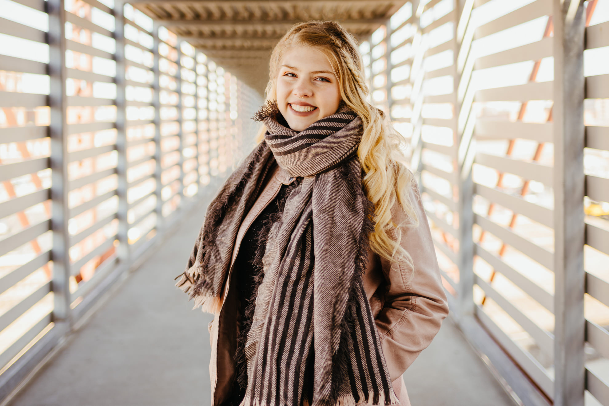 winter senior photo on pedestrian bridge at union station kansas city