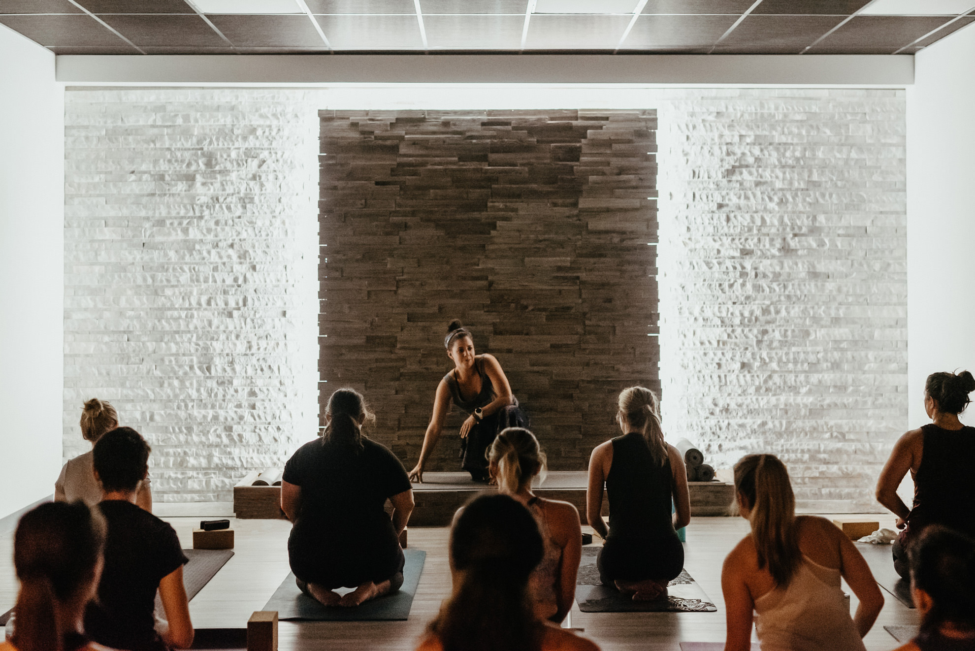 yoga class being taught in yoga studio