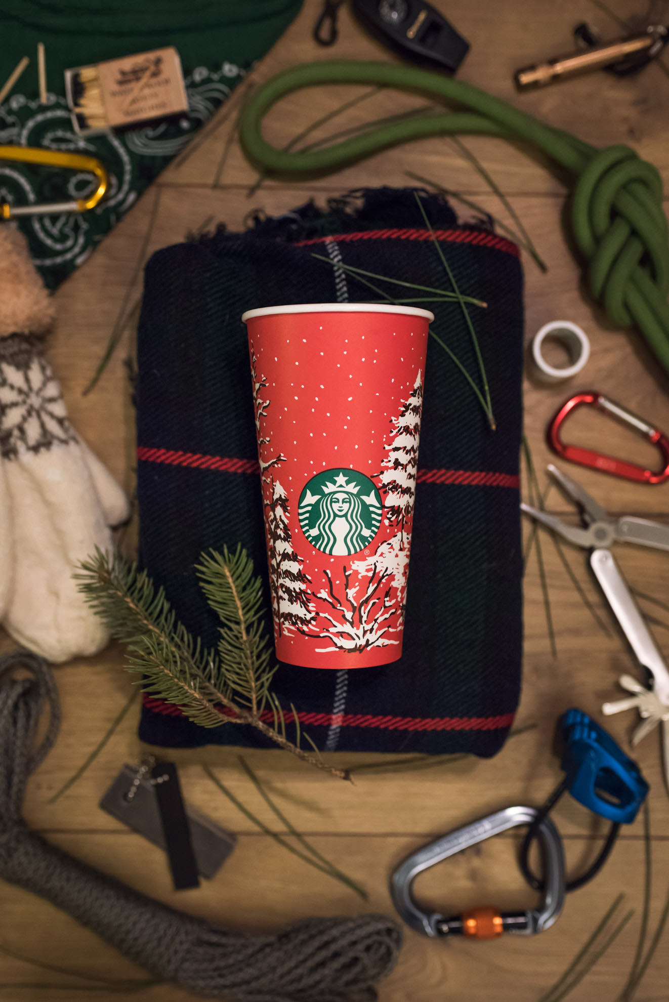 starbucks holiday cup in winter climbing themed flatlay